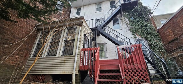 35 James St, Newark, NJ 07102 - view of side of home featuring stairway and brick siding
