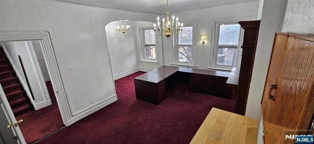 35 James St, Newark, NJ 07102 - unfurnished office with a healthy amount of sunlight, baseboards, arched walkways, and dark colored carpet