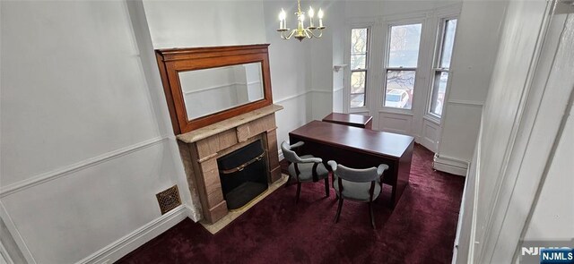 35 James St, Newark, NJ 07102 - dining room with carpet, a notable chandelier, visible vents, a fireplace with flush hearth, and a baseboard heating unit