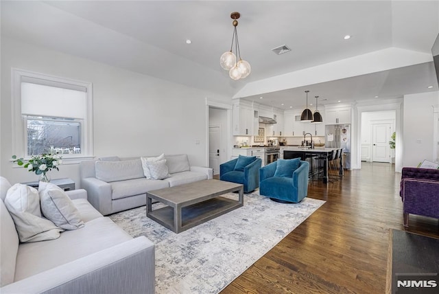 living room with visible vents, dark wood-style flooring, and recessed lighting