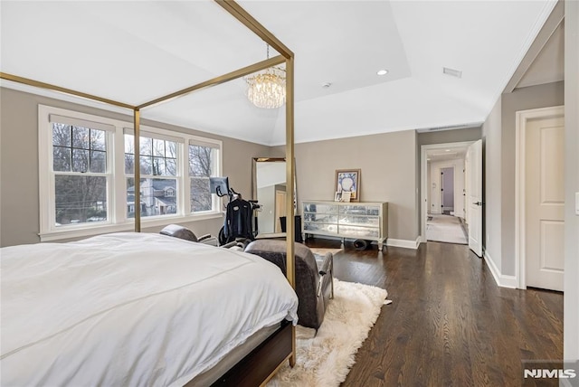 bedroom featuring lofted ceiling, an inviting chandelier, baseboards, and wood finished floors