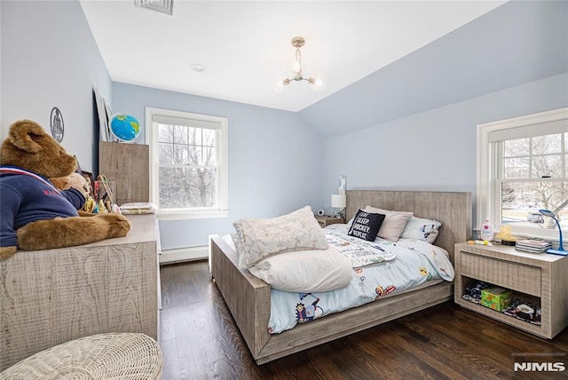 bedroom with a notable chandelier, a baseboard heating unit, wood finished floors, visible vents, and vaulted ceiling