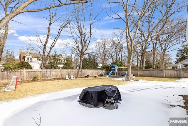 view of yard featuring a fenced backyard and a playground