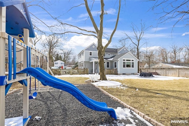 view of play area featuring a yard, a residential view, and fence