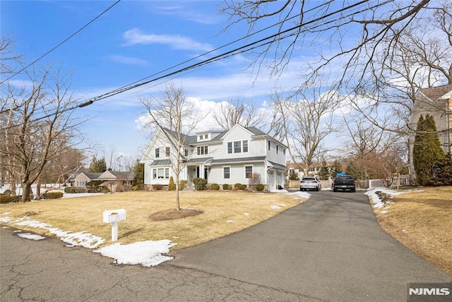 shingle-style home featuring driveway