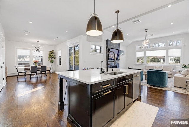 kitchen with visible vents, dark wood-style floors, open floor plan, light countertops, and a sink