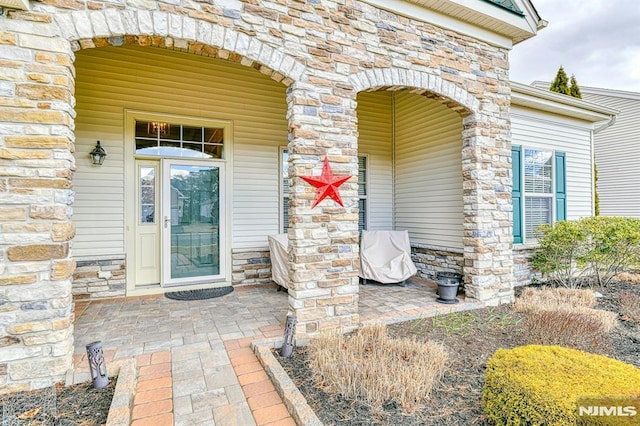 doorway to property featuring stone siding