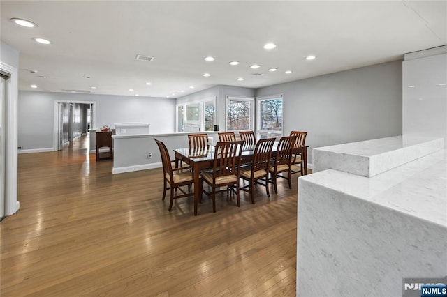 dining space featuring baseboards, hardwood / wood-style floors, visible vents, and recessed lighting