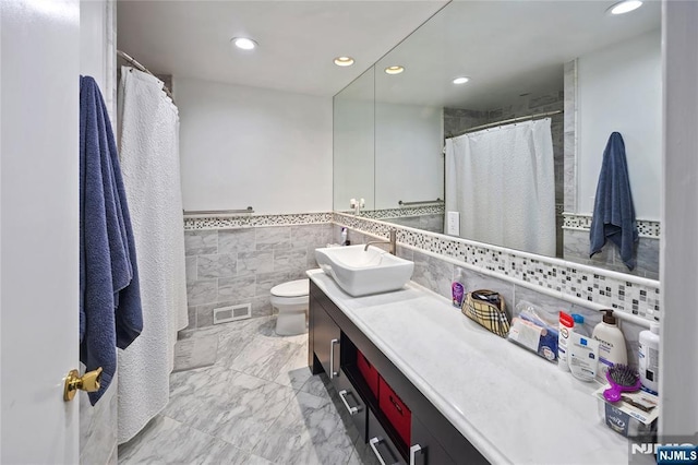 full bathroom with visible vents, toilet, marble finish floor, vanity, and recessed lighting