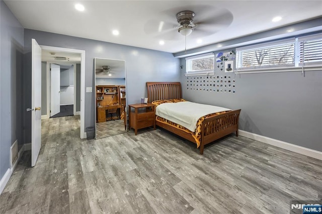 bedroom featuring ceiling fan, recessed lighting, wood finished floors, visible vents, and baseboards