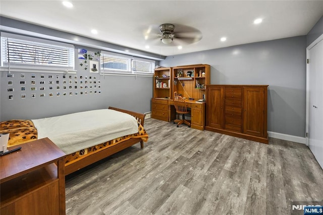 bedroom featuring baseboards, light wood-type flooring, and recessed lighting