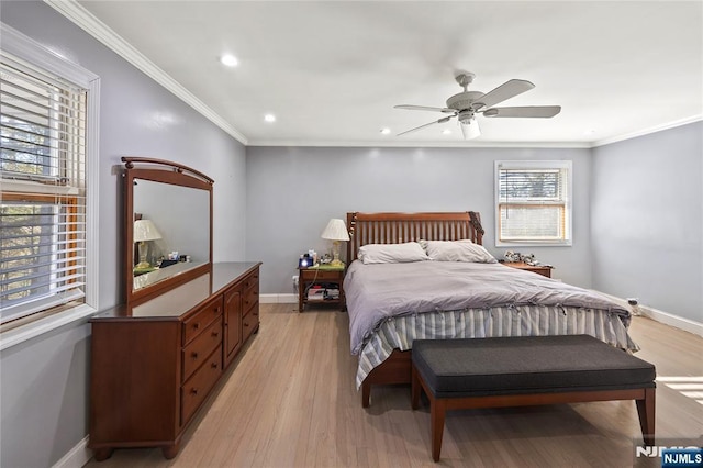 bedroom featuring light wood finished floors, baseboards, and ornamental molding