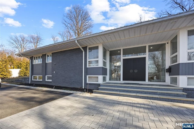 property entrance with brick siding