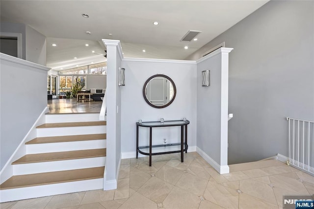 stairs with lofted ceiling, recessed lighting, visible vents, tile patterned flooring, and baseboards