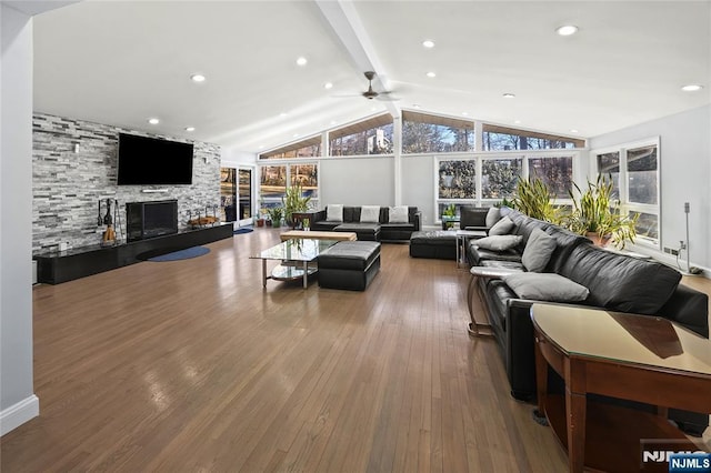 living room with a fireplace, vaulted ceiling with beams, recessed lighting, ceiling fan, and hardwood / wood-style floors