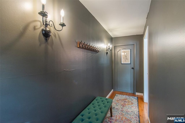 doorway featuring light wood-style floors and baseboards