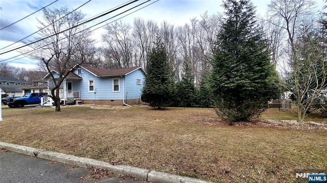 view of side of property with a lawn