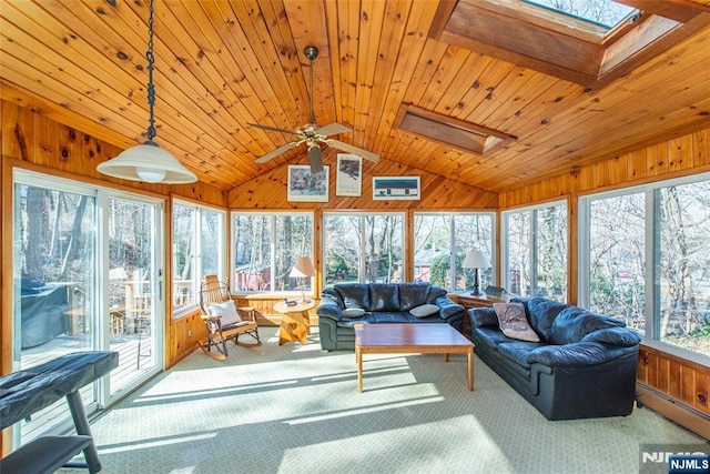 sunroom featuring a baseboard heating unit, vaulted ceiling with skylight, and wood ceiling