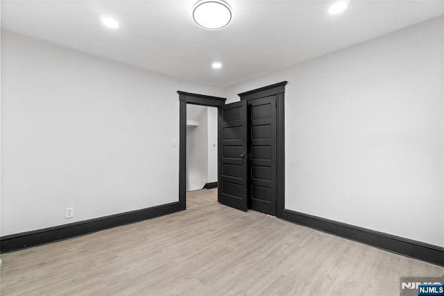 unfurnished room with recessed lighting, baseboards, and wood finished floors