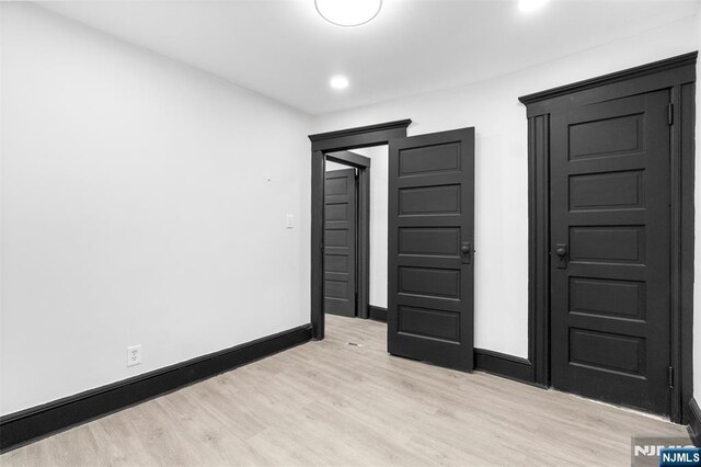 unfurnished bedroom with light wood finished floors, baseboards, and recessed lighting