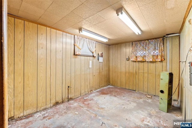 finished basement featuring wooden walls