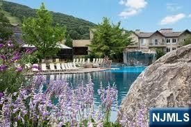 view of pool with a water and mountain view