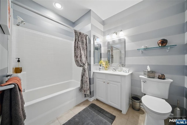 full bathroom with vanity, shower / bath combo with shower curtain, tile patterned flooring, and toilet