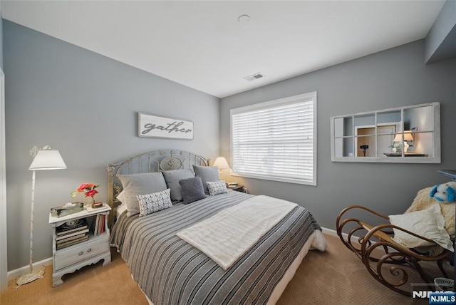 bedroom with light colored carpet, visible vents, and baseboards