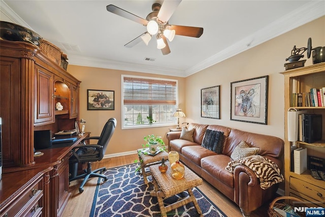 office area featuring light wood-style floors, visible vents, crown molding, and a ceiling fan