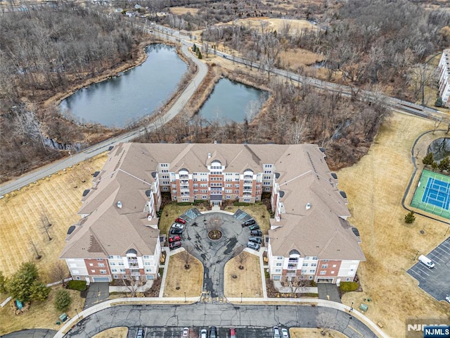 birds eye view of property with a water view