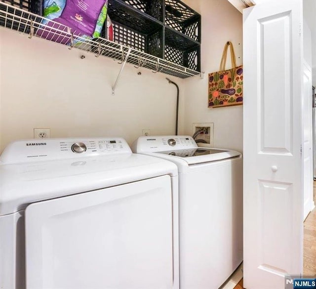 clothes washing area featuring laundry area and separate washer and dryer