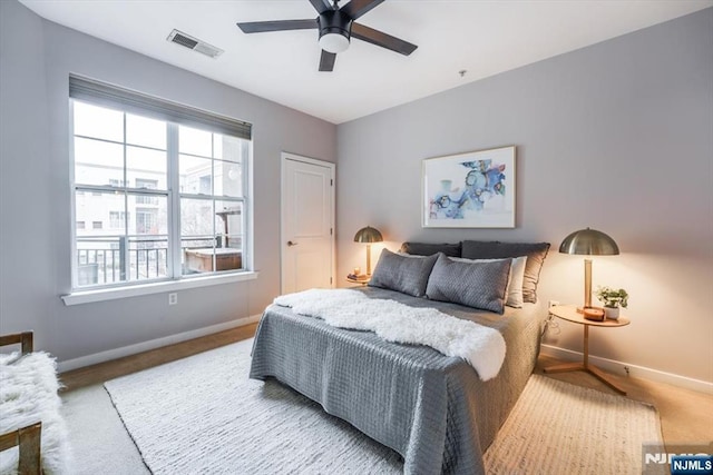 bedroom with a ceiling fan, visible vents, and baseboards