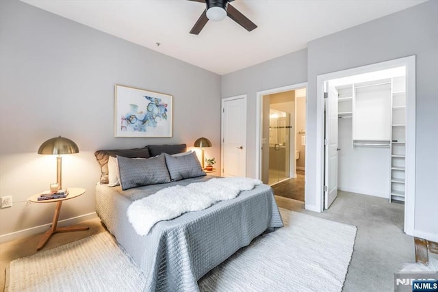 bedroom with baseboards, ceiling fan, a spacious closet, carpet floors, and a closet