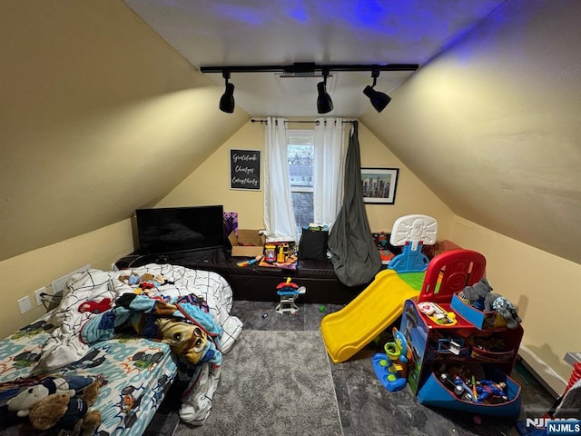 bedroom featuring lofted ceiling and rail lighting