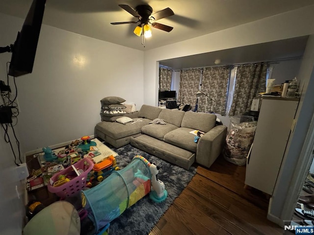 living room featuring wood finished floors and a ceiling fan