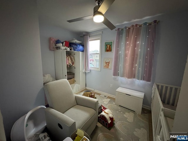 interior space featuring ceiling fan and baseboards