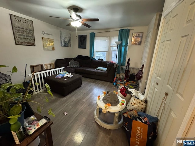 living room with wood finished floors and a ceiling fan