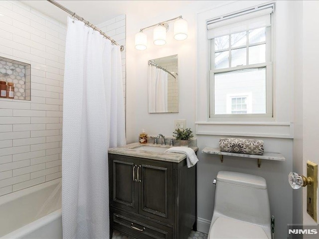 full bathroom with shower / bath combo, vanity, and toilet