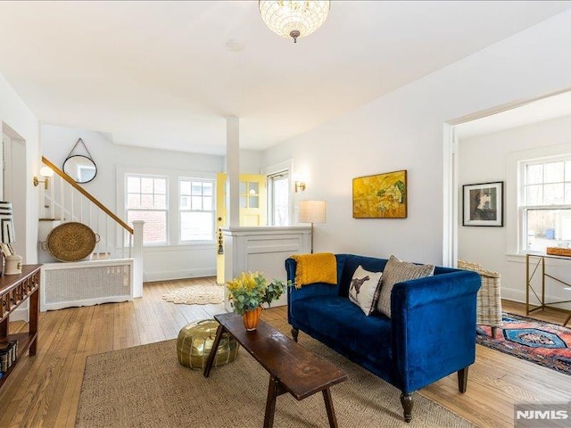 living room with stairs, baseboards, and hardwood / wood-style flooring