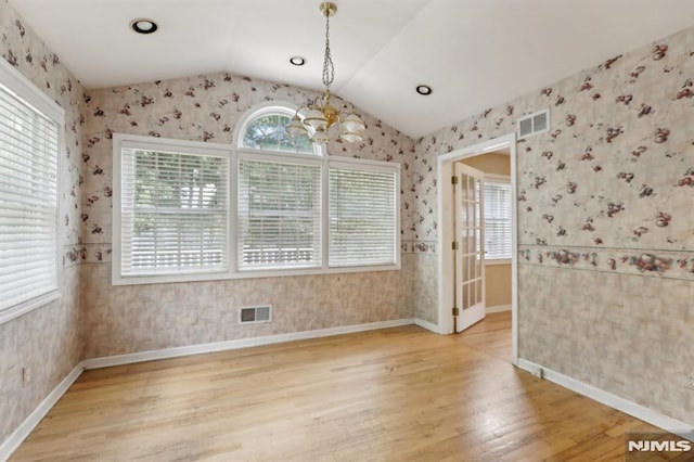 unfurnished dining area with a wealth of natural light, visible vents, and wallpapered walls