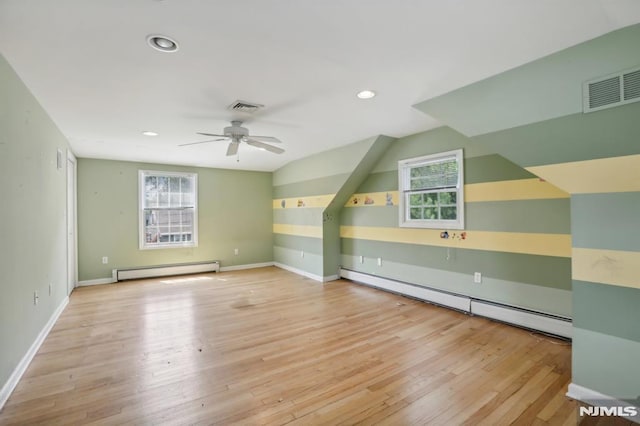 bonus room featuring visible vents, wood finished floors, and a baseboard radiator