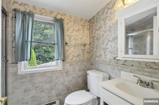 full bath with wallpapered walls, a wealth of natural light, and wainscoting