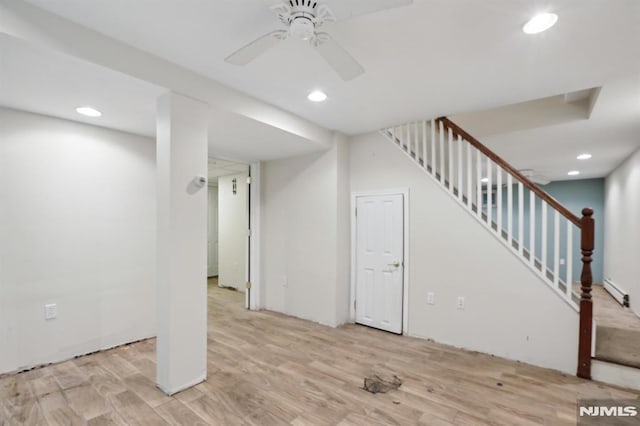 finished basement with recessed lighting, stairway, light wood-style floors, and a ceiling fan