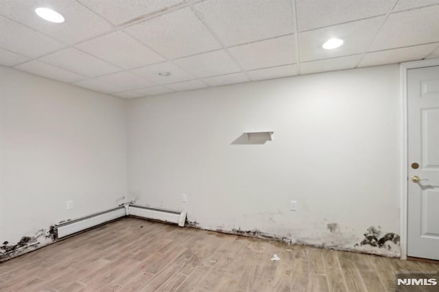 laundry room featuring baseboard heating and wood finished floors