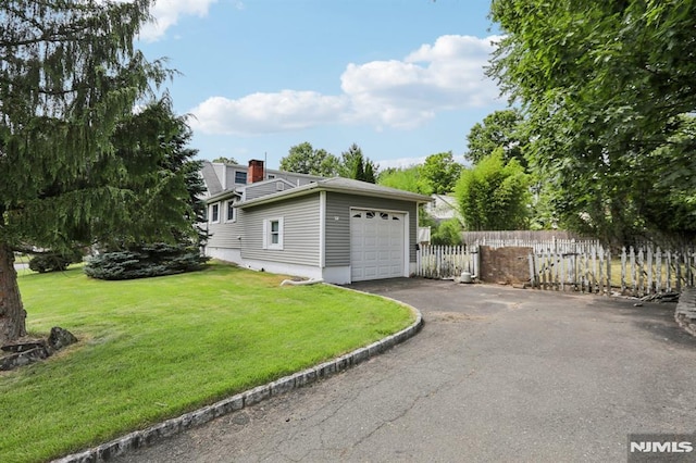 exterior space with aphalt driveway and fence