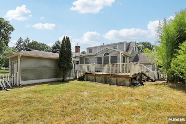 back of house with a deck, stairway, a yard, and fence