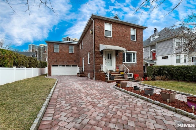 view of front of house with a garage, decorative driveway, brick siding, and fence