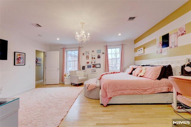 bedroom with light wood finished floors, visible vents, a notable chandelier, and recessed lighting