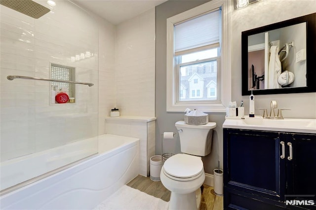 full bath featuring vanity, shower / bathing tub combination, wood finished floors, and toilet