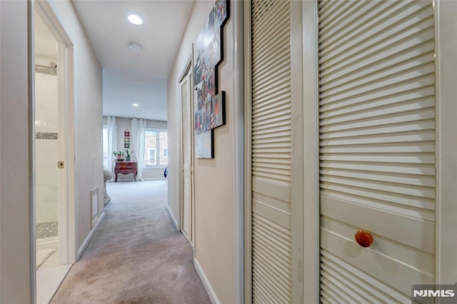 hallway with carpet, baseboards, and recessed lighting